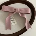 Rosafarbene Strick-Haarspange mit Schleife aus Wolle und elegantem Vintage-Etikett - Rosa