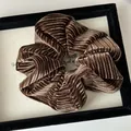 Chic oversized brown velvet scrunchie with vertical ribbed texture and elegant folds - Coffee
