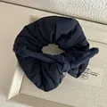 Detailed macro shot of the dark fabric scrunchie with a woven cotton rope tie - Navy Blue
