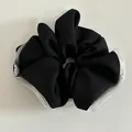 Close-up of black scrunchie with white lace edge and delicate pearl embellishments - Black