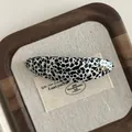Close-up of Dalmatian print acetate hair clip featuring a gold France Handmade logo - Black and White Spots