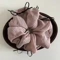 Pink oversized scrunchie with pleated fabric texture and delicate black ribbon bows - Pink