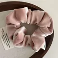 Close-up of dusty pink velvet scrunchie showing soft texture and premium glossy finish - Pink