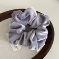 Elegant lavender velvet scrunchie for women on a rustic wooden tray decoration - Purple