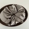 Detailed close-up of a large satin scrunchie in champagne gold on a wooden tray - Grey Brown