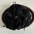 Detail of black chiffon scrunchie with ribbon bows on a minimalist wooden tray - Black