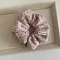 Floral cutout pink scrunchie with Happy Every Day label on beige display tray - Pink