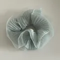 Detailed view of light blue pleated organza scrunchie with soft ruffled fabric texture - Mint