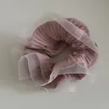 Detail of pink pleated organza scrunchie featuring ruffled white translucent edges - Pink