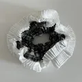 Detail of checkered fabric and white pleated lace edge on a large scrunchie - Black