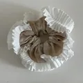 Detail of checkered fabric scrunchie with pleated white lace trim and elastic structure - Apricot