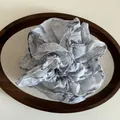Elegant light grey floral organza scrunchie displayed on a dark wooden tray accessory - Blue