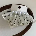 Detail of French polka dot mesh hair clip with five graduated white pearls on a card - Off-white