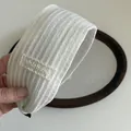 Detail of white ribbed lace headband with shishang embroidery on a wooden tray - Off-white