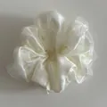 Detail of multi-layered pearl white organza scrunchie with soft pleated texture - White