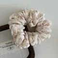 Primer plano de coletero vintage francés con estampado floral naranja sobre tela crema - Beige