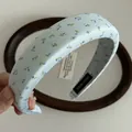Detail of handmade light blue floral headband with vintage fabric and interior woven label - Light Blue