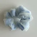 Close-up of double-layered blue satin and white organza scrunchie with soft pleated texture - Blue