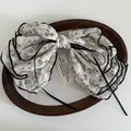 French vintage floral bow hair clip in cream fabric with black ribbons and wavy edges - Grey-Beige