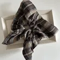 Vintage oversized brown and beige plaid scrunchie in a textured fabric on a display tray - Khaki