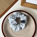 Coletero minimalista azul claro con etiqueta tejida negra smile en plato de cerámica - Azul