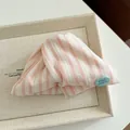 Pink and white striped fabric hair claw clip with light blue oval logo detail - Pink