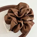 Detail of premium heavy satin oversized scrunchie in dark brown with rich silk texture - Brown