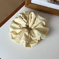 Pale yellow cream scrunchie with soft fabric texture and elegant pleated design - Light Yellow