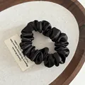 Classic black satin scrunchie with soft pleated texture and high elastic hair tie - Black