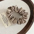 Elastic satin scrunchie in champagne gold with a luxurious glossy finish and soft pleats - Khaki