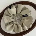 Sage green fabric scrunchie with a Hand Made label on a wooden display tray - Pleated Handmade Label Style / Matcha Green