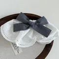 Detailed view of white floral lace hair clip with a grey plaid bow and embroidery - Vintage Dark Grey