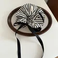 Detail of striped scrunchie with long satin ribbon and handmade label in a wooden tray - Streamer Scrunchie