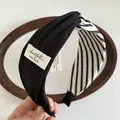 Chic black and white striped fabric knot headband with handmade woven label detail - Headband