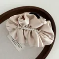 Elegant champagne satin hair claw clip with white pearl wrap for women's hair styling - Beige