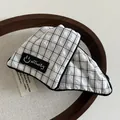 Plaid fabric hair claw clip featuring black and white pattern with Affinity logo label - White Grid