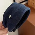 Puffy navy blue fabric headband with denim texture and golden emblem detail - Navy Blue