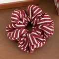 Detail of red and white striped knit fabric texture on a soft oversized scrunchie accessory - Red