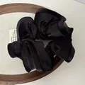 Lustrous black velvet oversized scrunchie hair tie with elegant pleated texture - Black