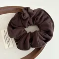 Detail of dark brown wool fabric scrunchie with soft brushed texture and pleated design - Dark Coffee