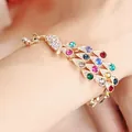 Colorful peacock bracelet with sparkling rhinestones and adjustable gold-tone chain on wrist - Colorful Peacock