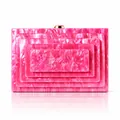 Detail view of hot pink marbled acrylic clutch bag featuring layered rectangular design - Rose Red