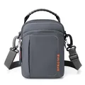 Deep grey tactical crossbody bag with orange logo and adjustable shoulder strap - Gray