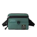 Dark green crossbody shoulder bag with high-density nylon texture and dual zip pockets - Dark Green