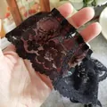 Intricate black floral lace trim for Lolita dresses held by hand to show detail - Black