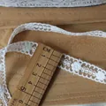 Macro shot of 1.5cm white floral lace trim with hollow embroidery on wooden background - Continuous 5-Petal Flower Style (4#) / Width About 1.5cm Length 1 Meter