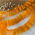 Close-up of pleated orange lace trim with mesh texture for DIY sewing and clothing decor - Orange Pleated Mesh (Style No. 6)