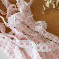 Pink checkered elastic lace trim with white ruffled edges on a rustic wooden background - White with Pink