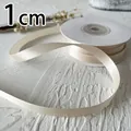 Detalle de cinta de raso crema de 1cm de ancho con textura de seda suave para manualidades - Amarillo crema