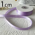 Macro detail of 1cm wide lavender double-sided satin ribbon roll for DIY crafts - Light Purple